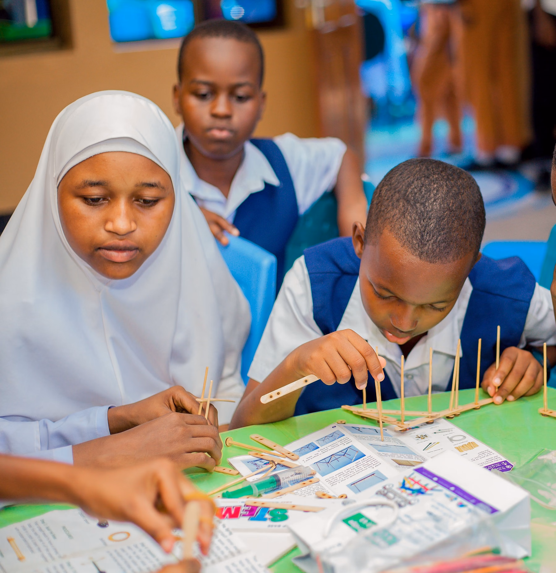 Students building an engineering model together during a practical STEM activity